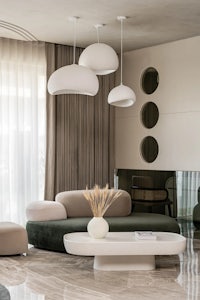 a modern living room with white furniture and a coffee table